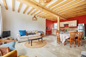 a living room with a table and a couch at La Tourelle de Saint Michel de Livet - Parking in Livarot +10 photos