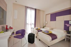 A bed or beds in a room at AS Hotel Limbiate Fiera