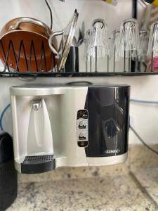 a coffee maker sitting on top of a counter at Casa em Barueri in Barueri