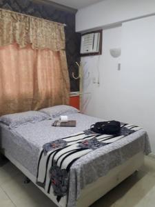 a bedroom with a bed with a towel on it at Studio Centro Floripa 05 in Florianópolis