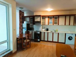 a kitchen with a table and a dining room at Riviera Fort Beach Apartment in Ravda