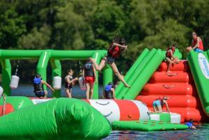 a group of people playing on an inflatableuin in the water at Loft Apartment at Moulin SAGE in Treignac