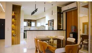 a kitchen and dining room with a table and chairs at Fully furnished Townhouse in Abū Rawwāsh