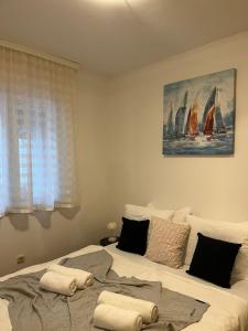 a bedroom with a bed with towels on it at Apartment Val in Dubrovnik