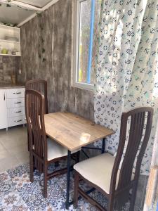 a kitchen with a wooden table and two chairs at ZBB Villa & Bungalow in Alanya