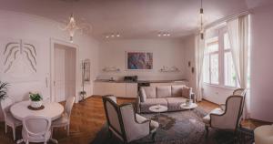a living room with a couch and a table and chairs at AB Ljubljana - Prince Filip Apartment in Ljubljana