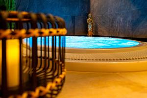a large pool of water in a room with chairs at Hotel NOBILIS - Mladá Boleslav in Bradlec