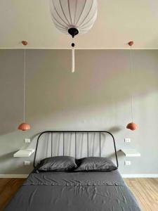 a bedroom with a bed and a chandelier at Milano Fair Apartment in Pero