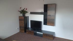a living room with a tv and a mirror at Apartmán v podkroví Olomouc in Olomouc