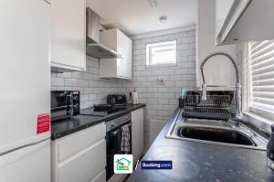 a kitchen with a sink and a counter top at Four Bedroom House in Preston Perfect for Contractors in Preston
