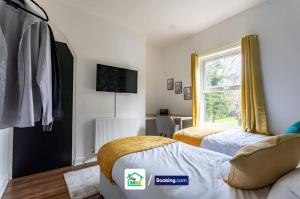 a bedroom with two beds and a window at Four Bedroom House in Preston in Preston +13 photos