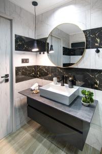 a bathroom with a sink and a mirror at K-Alex Domus in Alexandroupoli in Alexandroupoli +57 photos