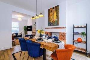 a dining room with a table and blue chairs at Stylish 3-Bed City Centre Home in Chester by 53 Degrees Property, Ideal for Groups, Private Parking! in Chester