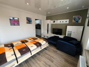 a bedroom with a bed and a couch in it at Apartment in Rösrath nahe Messe in Rösrath