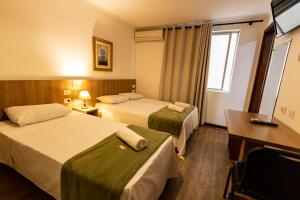 En eller flere senge i et værelse på Hotel Golden Star