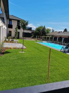 a yard with a swimming pool in a house at Pipacs 17 by HelloBalatonlelle in Balatonlelle