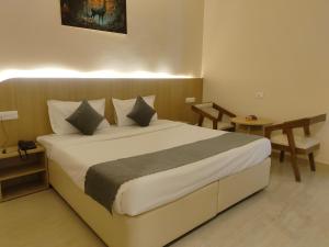 a bedroom with a large bed in a room at Hotel Meridian Blue in Warangal