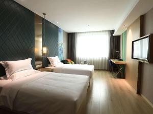 Postel nebo postele na pokoji v ubytování Ibis Styles XM Zhongshan Hotel