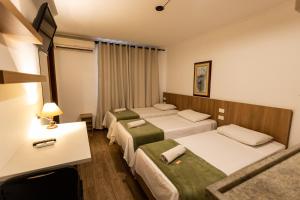 En eller flere senge i et værelse på Hotel Golden Star