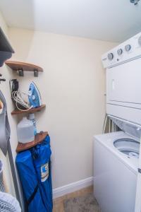 a laundry room with a washer and dryer at Family-Friendly Divi Golf Resort Steps to the Beach and Pool in Palm-Eagle Beach