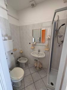 a bathroom with a toilet and a sink at Hotel Ideal in Arma di Taggia +30 photos