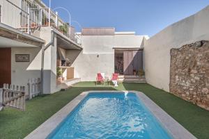 a swimming pool in the backyard of a house at Cal Cabrer in Sant Jaume dels Domenys