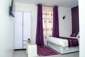 Postel nebo postele na pokoji v ubytování Nyams Boutique Hotel