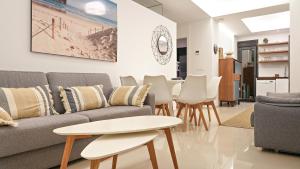 a living room with a couch and a table at Seaside Apartment in Arenales del Sol