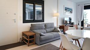 a living room with a couch and a table at Seaside Apartment in Arenales del Sol