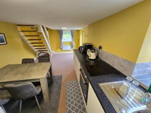 a kitchen with a counter and a staircase in a room at Gower Fresh Christmas Trees in Penclawdd