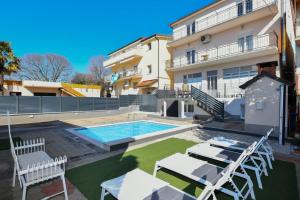 a house with a swimming pool and some tables and chairs at Apartment Dijana with private pool in Donji Proložac