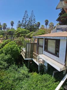 a house sitting in the grass with trees in the background at Una vista impresionante in Mirasol