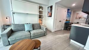 a living room with a couch and a table at Sky-High oasis Large Studio POOL & GYM in Miami +45 photos