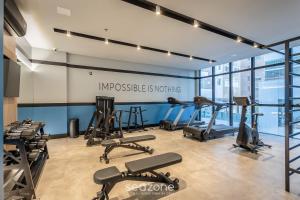 a gym with treadmills and exercise equipment in a building at IFT - Ed. Infinity Tower Flat 350m da Meia Praia in Meia Praia