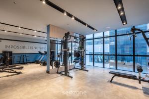a gym with several treadmills and exercise equipment in a building at IFT - Ed. Infinity Tower Flat 350m da Meia Praia in Meia Praia