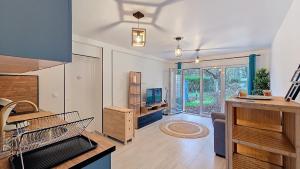 a large room with a kitchen with a tv at Studio Cosy entre Paris-Disney in Chelles
