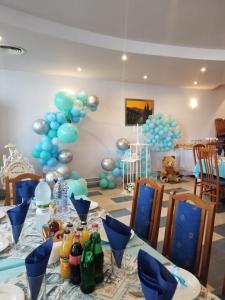 a table with blue and gray balloons and bottles on it at Hotel Evridika in Nesebar
