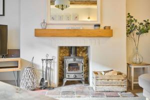 a living room with a fireplace and a mirror at Host & Stay - Rock Rose in Holt +13 photos
