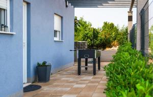 a barbecue grill on a patio outside of a house at 6 Bedroom Amazing Home In Bilice in Bilice
