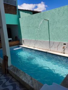 a swimming pool with a fountain in a building at Casa de praia Carneiros-Tamandaré in Tamandaré +10 photos
