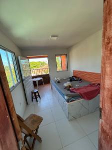 a room with a bed and a table in it at Casa de praia Carneiros-Tamandaré in Tamandaré