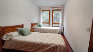 A bed or beds in a room at Martina VUT , Estación de Canfranc