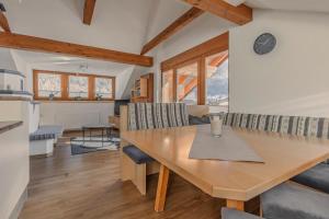 a kitchen and dining room with a wooden table and chairs at Ferienhaus Tirol im Ötztal in Umhausen