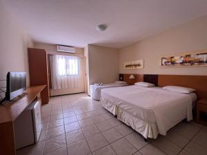 Giường trong phòng chung tại Aquaville Resort Piscinas Praia 2