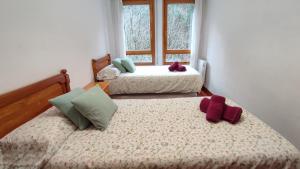 A bed or beds in a room at Martina VUT , Estación de Canfranc