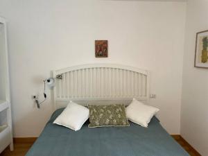 a bedroom with a bed with a pillow on it at Charme nel borgo - Appartamento Maria in Corniglio
