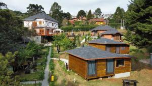 a group of houses on a hill with trees at Pousada Chales da Mantiqueira - Campos do Jordão in Campos do Jordão