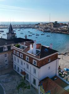 an aerial view of a building with boats in the water at Villa Cascais Boutique Hotel in Cascais