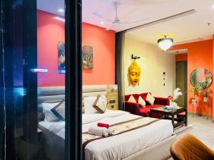 a hotel room with two beds and a couch at Supernova River View Studio in Noida