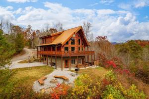 a large wooden house in the middle of a forest at Ridge View Lodge - Nature and Mountain View - Hot tub - Firepit - Yard - Games in Laurel